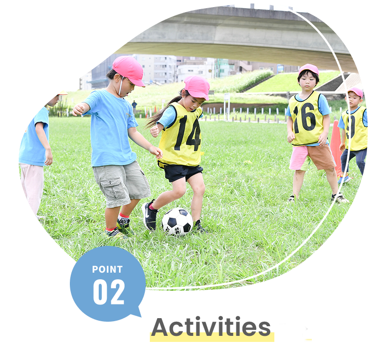 Children playing soccer together as part of outdoor activities at the nursery