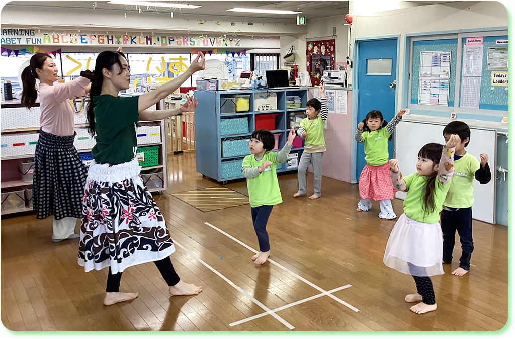 Children practicing hula dance with an instructor at the nursery.