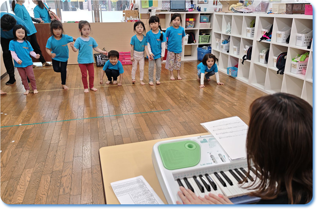 Children enjoying a rhythmic activity with keyboard accompaniment.